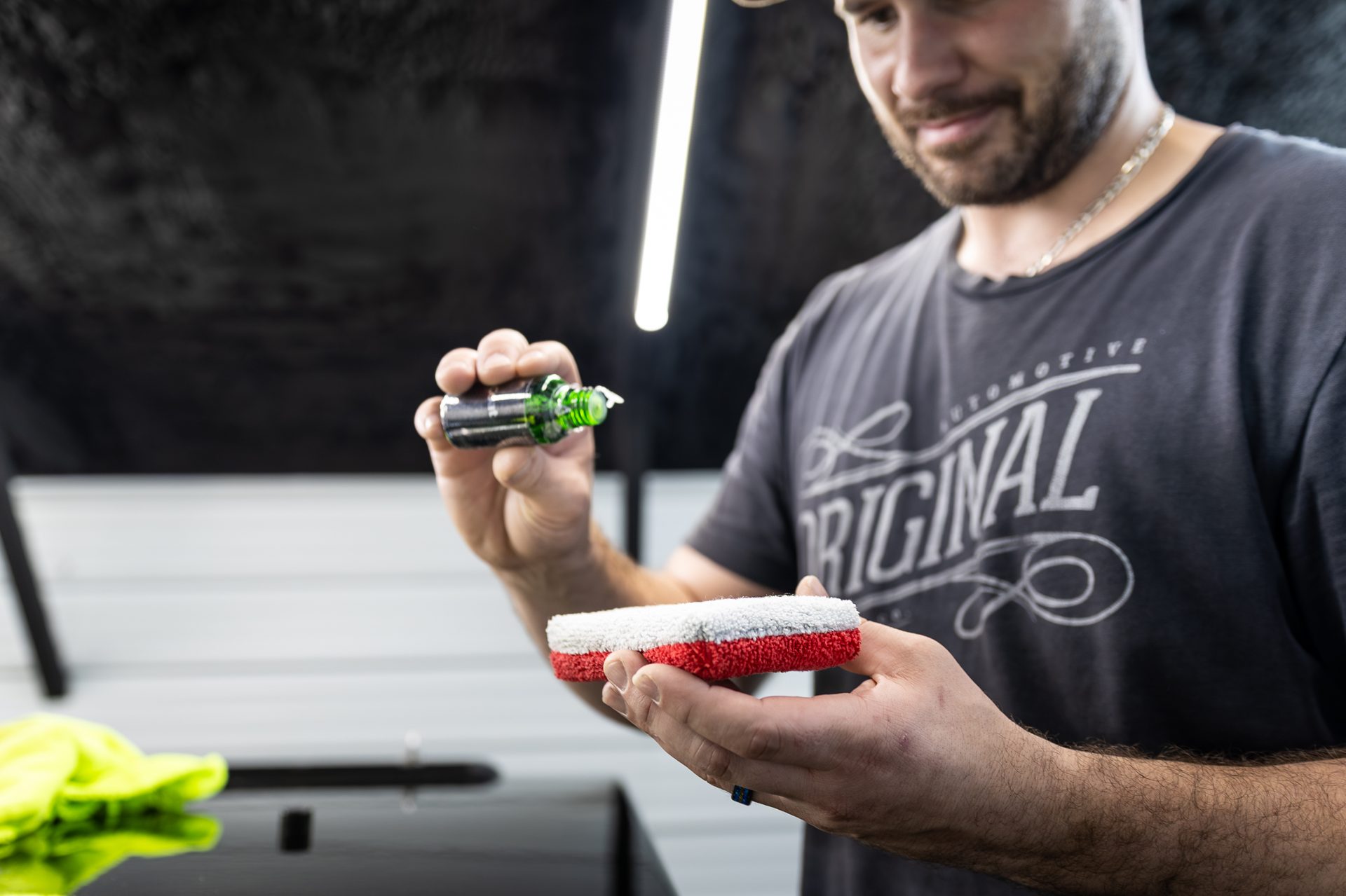 True Auto Growth co-owner applying a ceramic coating in the shop