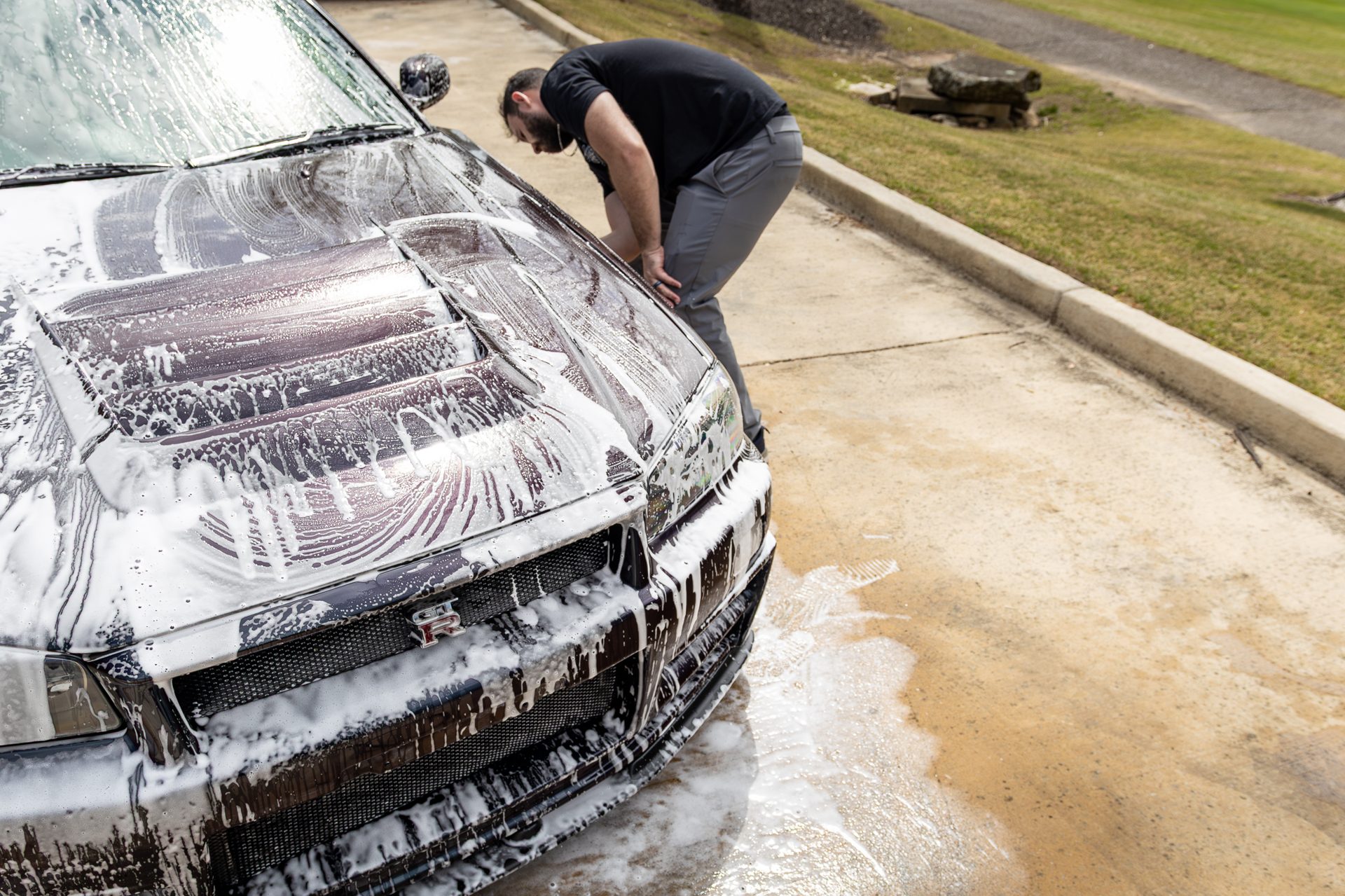 A vehicle covered in foam during a detailing wash