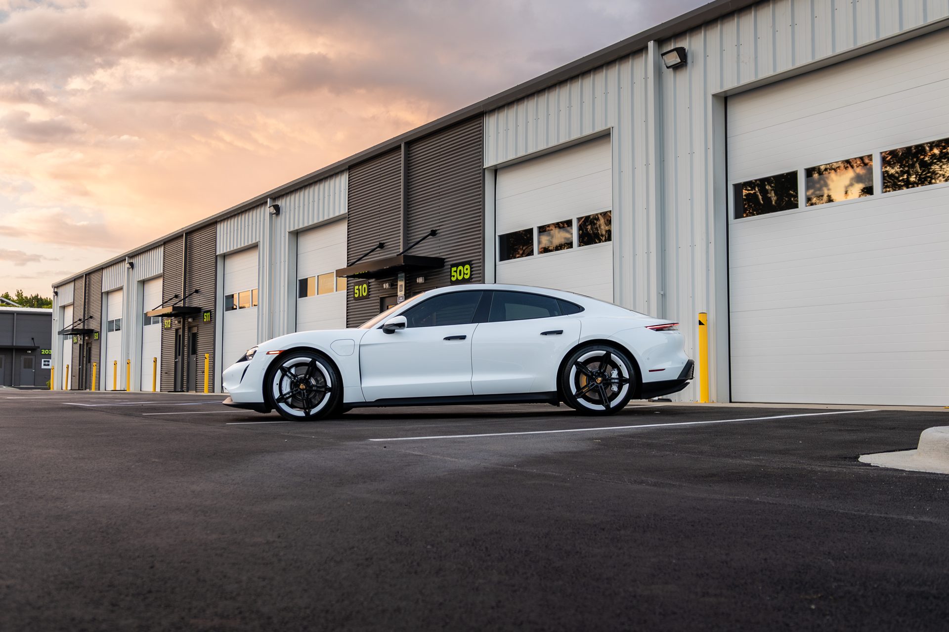 Porsche Taycan at sunset outside the shop