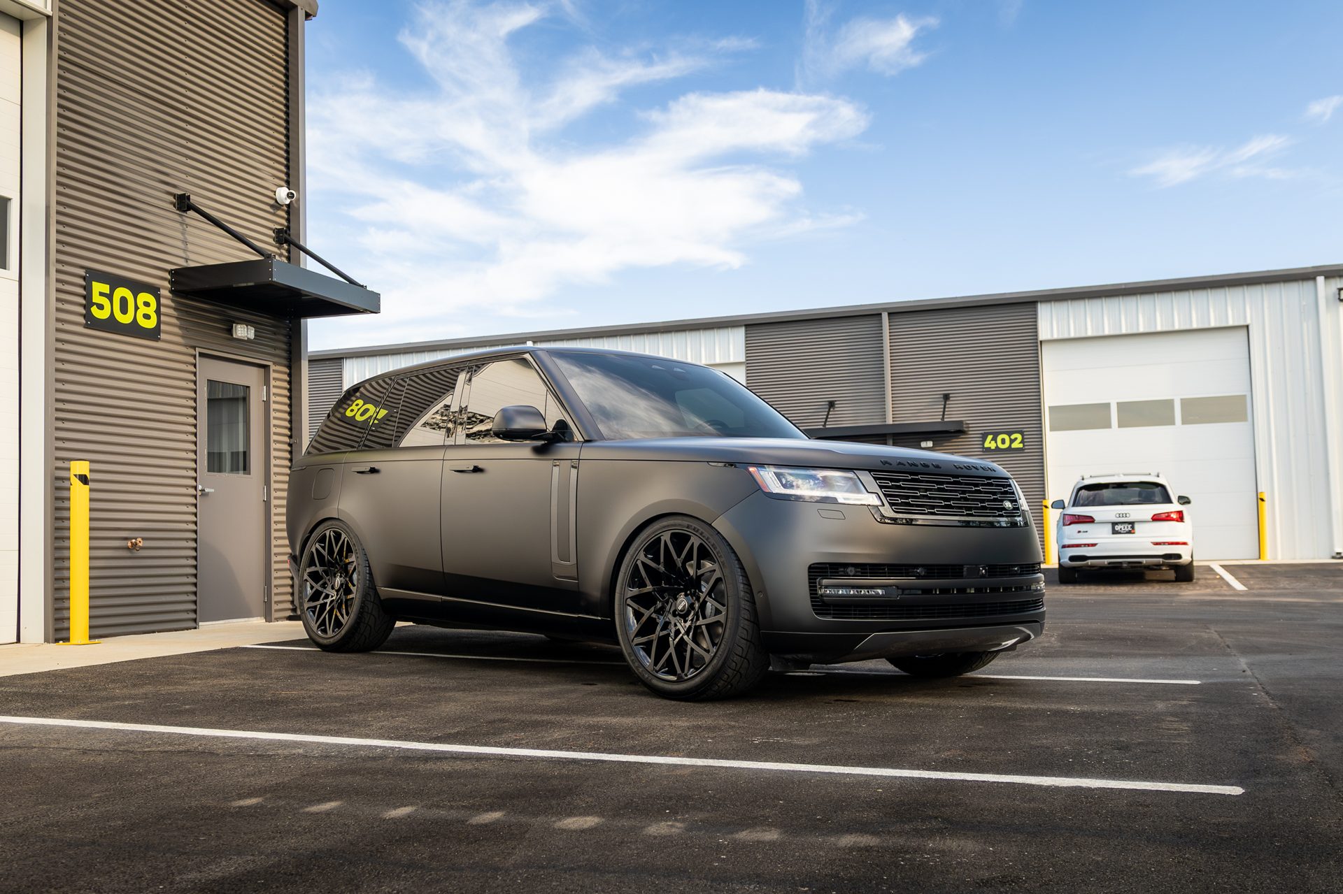 Matte-wrapped Range Rover outside the shop