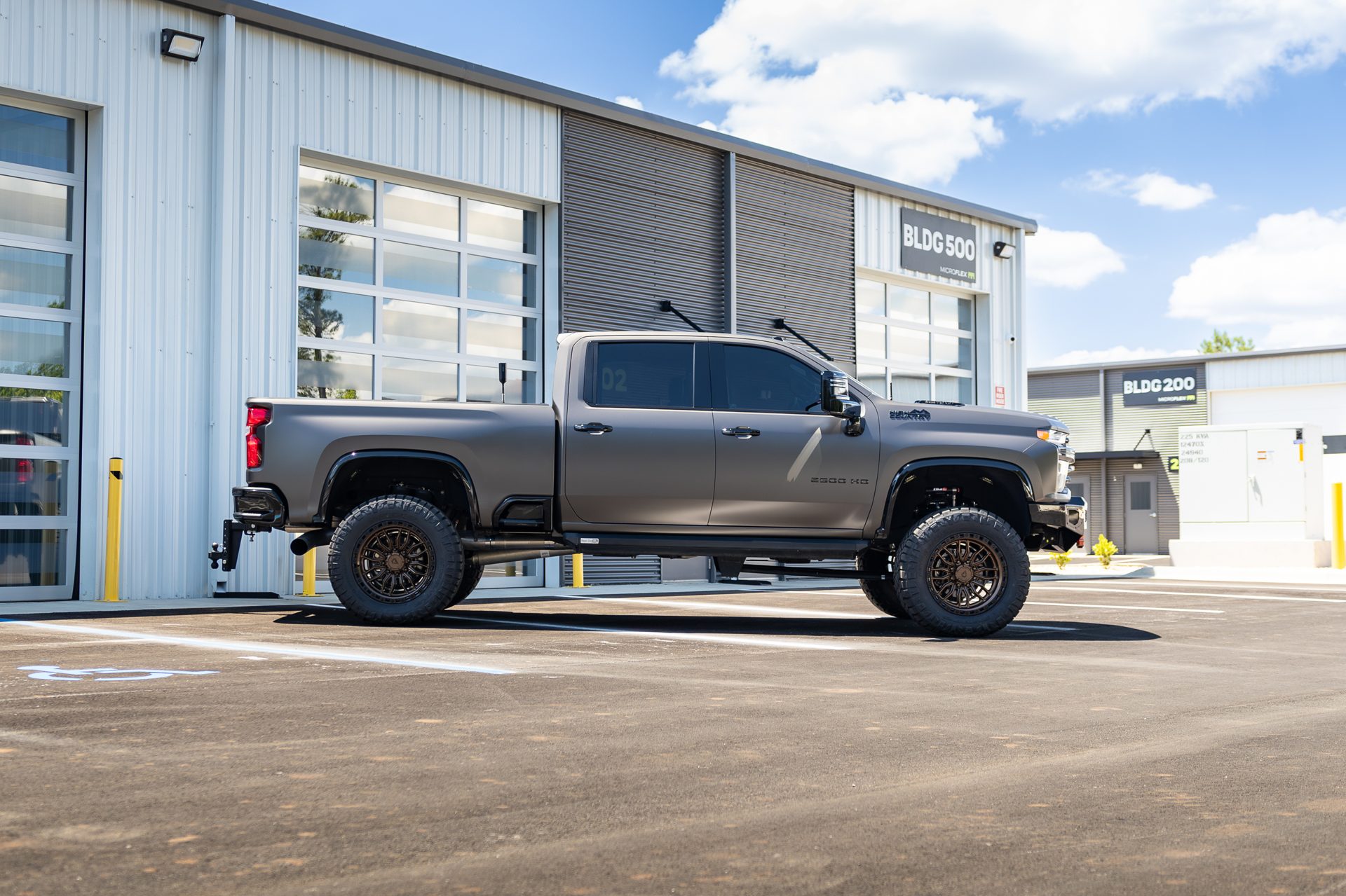 Matte vinyl-wrapped Silverado outside the shop