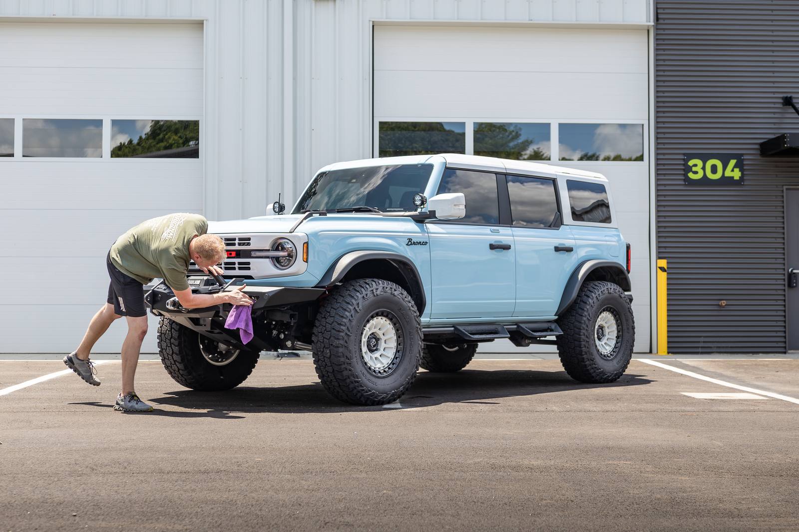 Final wipe down on a Bronco outside the bay doors